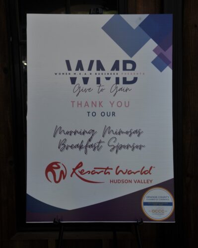 Event sponsorship sign with geometric shapes and sponsor logos, including a 'Thank you to our morning breakfast sponsor' message.